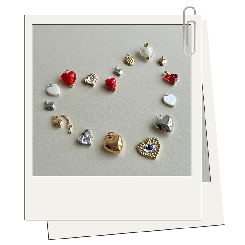 Collection of various heart-shaped charms on a gray card